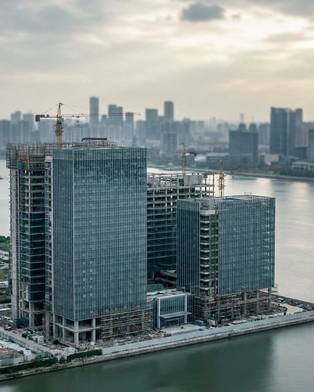 Waterfront towers under construction at dusk